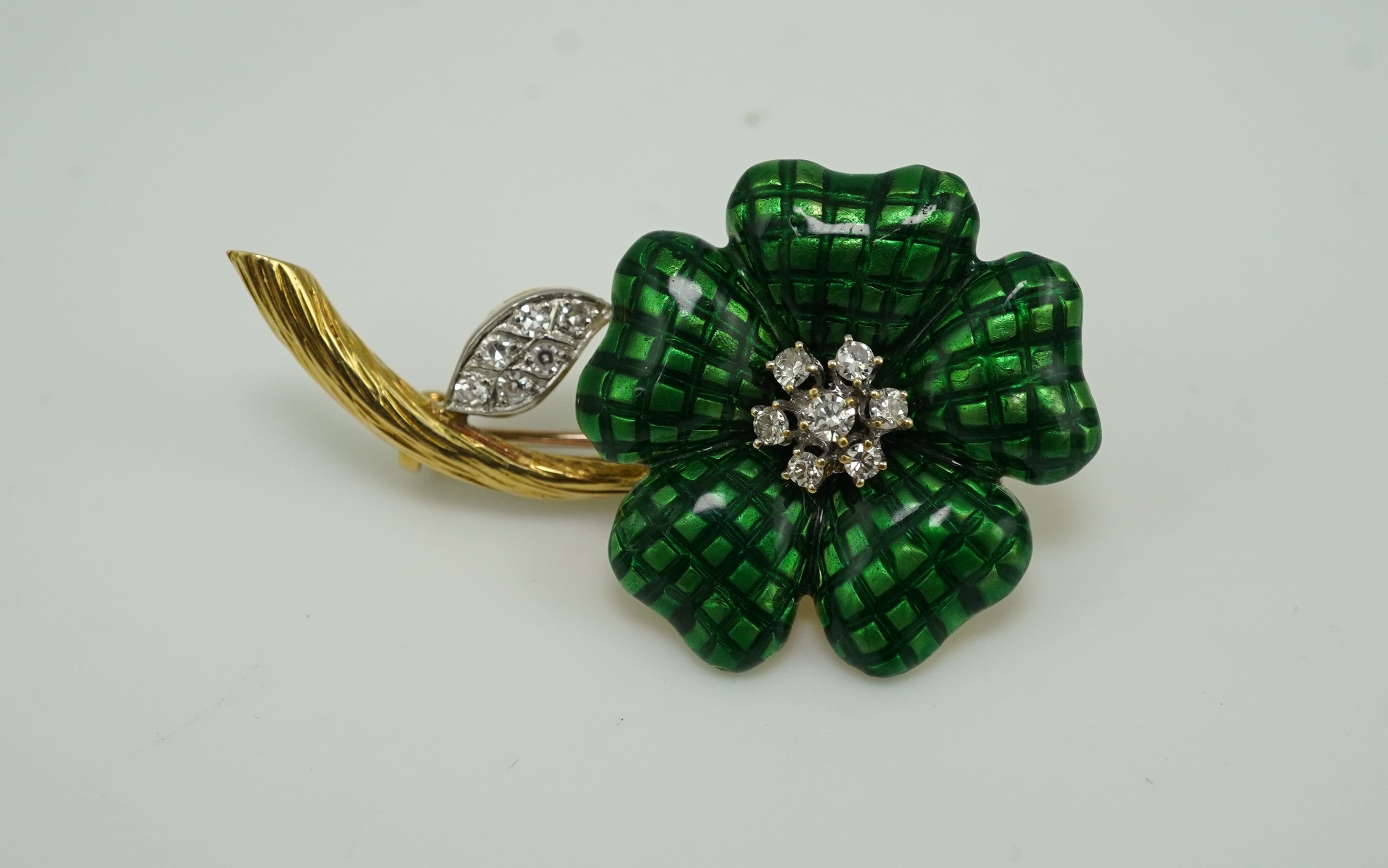 An enamel and diamond brooch